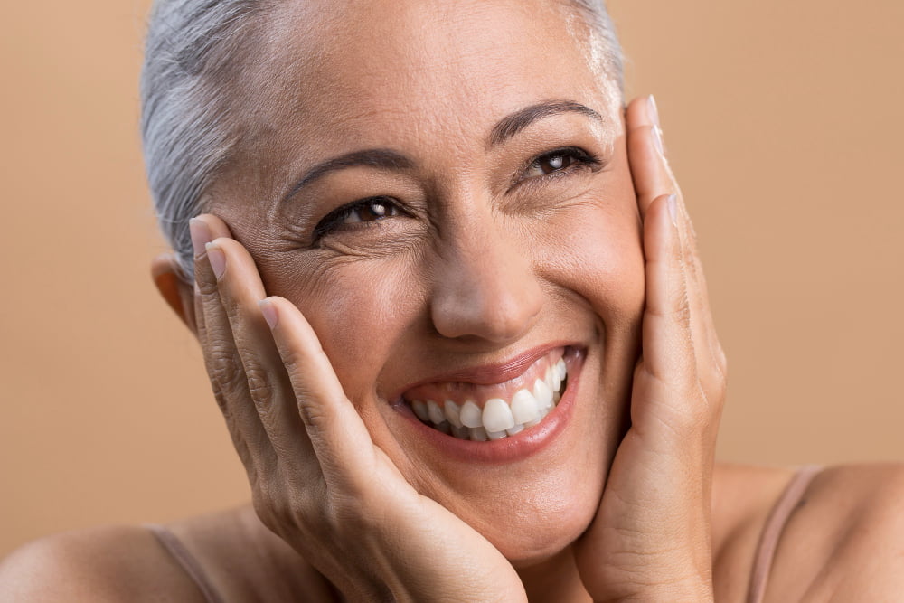 smiling woman using aklief cream
