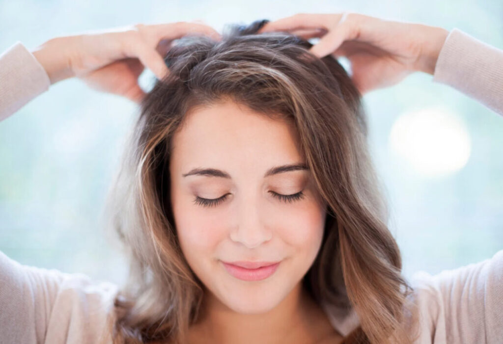 Soro capilar: Mulher massageando o couro cabeludo